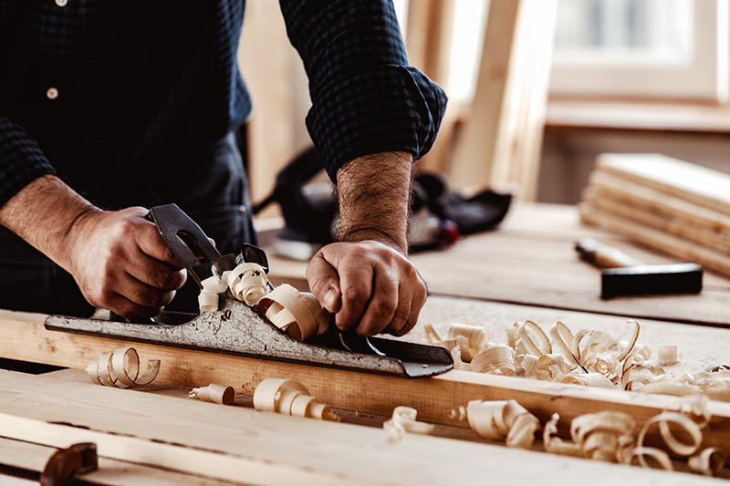 Guy planing wood